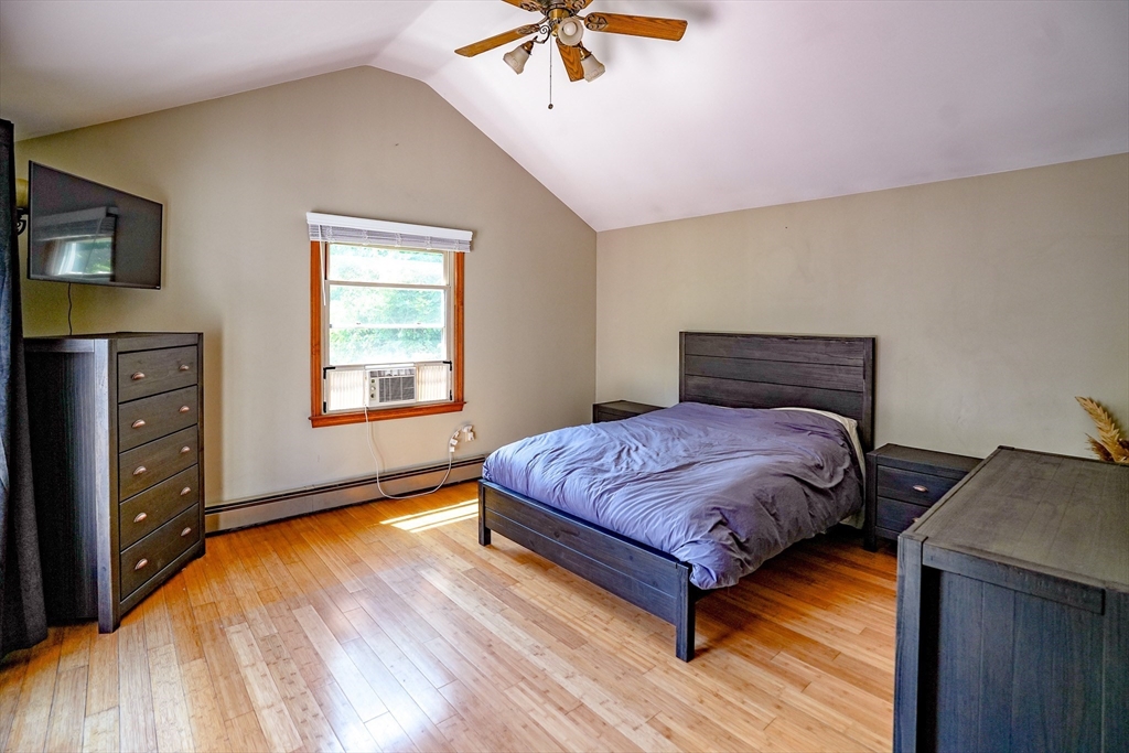 117 Main Street Rutland, MA 01543 - Photo 20 of 35 a bedroom with a bed and a chandelier