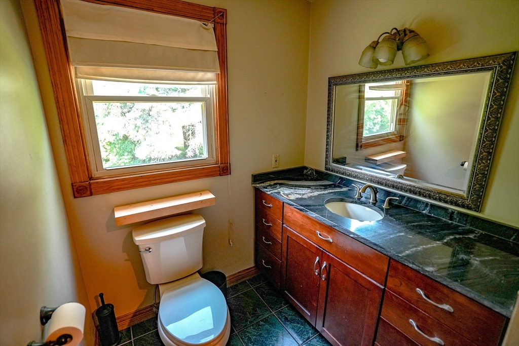 117 Main Street Rutland, MA 01543 - Photo 23 of 35 a bathroom with a granite countertop toilet sink and mirror