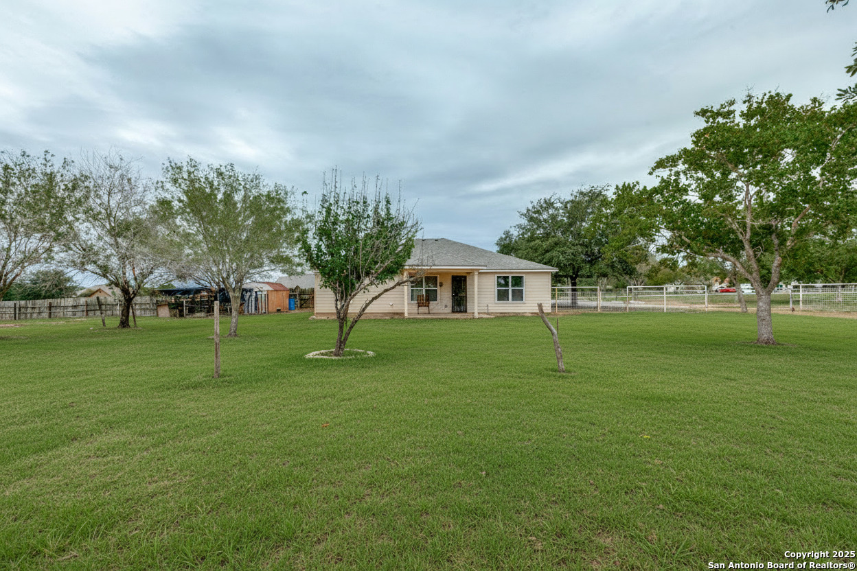745 Cimarron Square Poteet, TX 78065 - Photo 1 of 33 a front view of a house with a yard