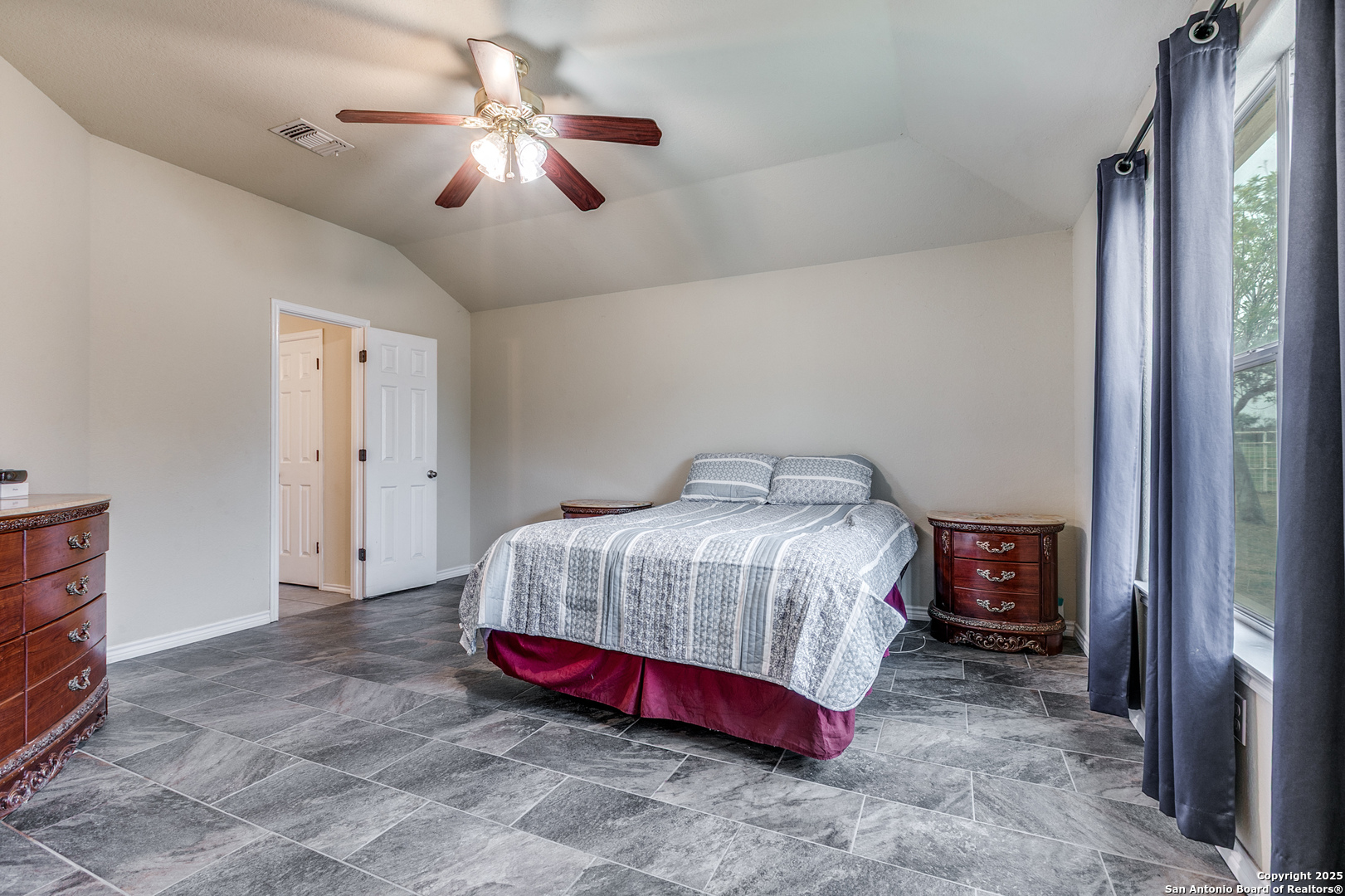 745 Cimarron Square Poteet, TX 78065 - Photo 15 of 33 a bedroom with a bed and a chandelier