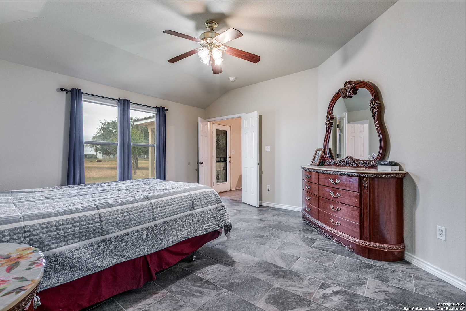 745 Cimarron Square Poteet, TX 78065 - Photo 16 of 33 a bedroom with a bed and a dresser
