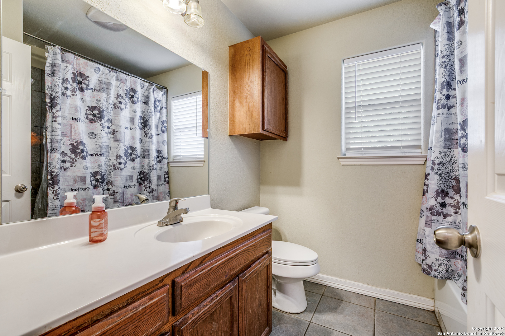 745 Cimarron Square Poteet, TX 78065 - Photo 19 of 33 a bathroom with a sink toilet and shower