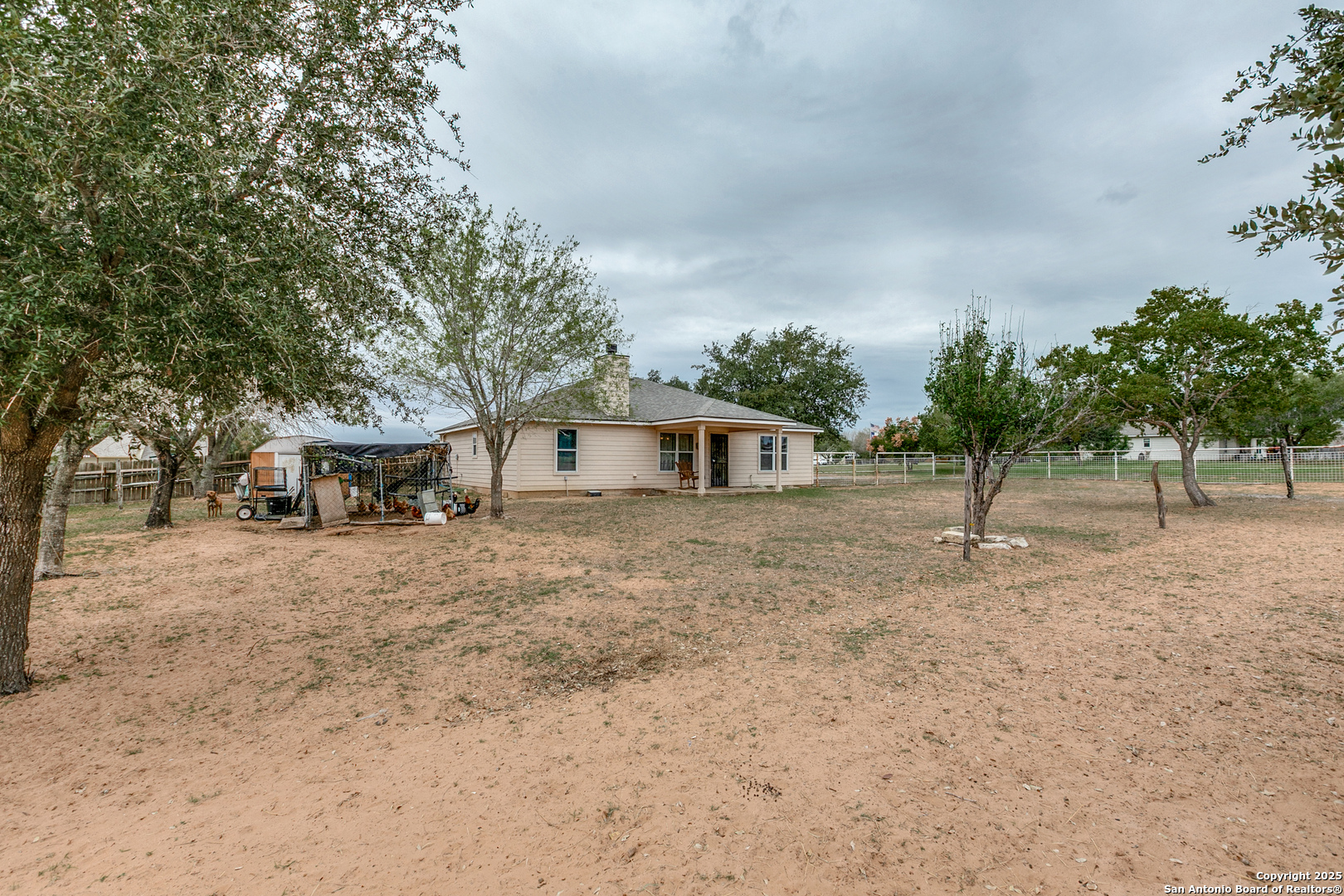 745 Cimarron Square Poteet, TX 78065 - Photo 29 of 33 a white house that has a tree in front of it
