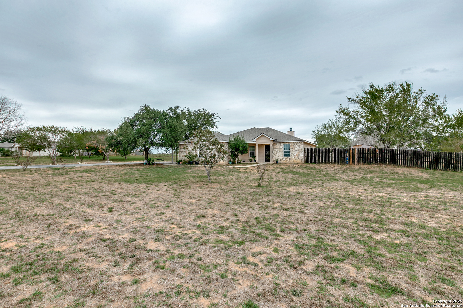 745 Cimarron Square Poteet, TX 78065 - Photo 33 of 33 a front view of a house with a yard