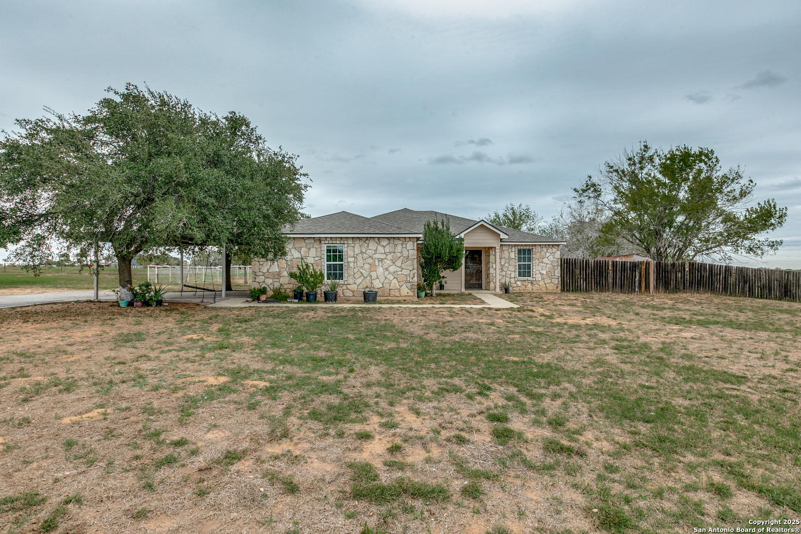 745 Cimarron Square Poteet, TX 78065 - Photo 6 of 33 a front view of a house with a yard