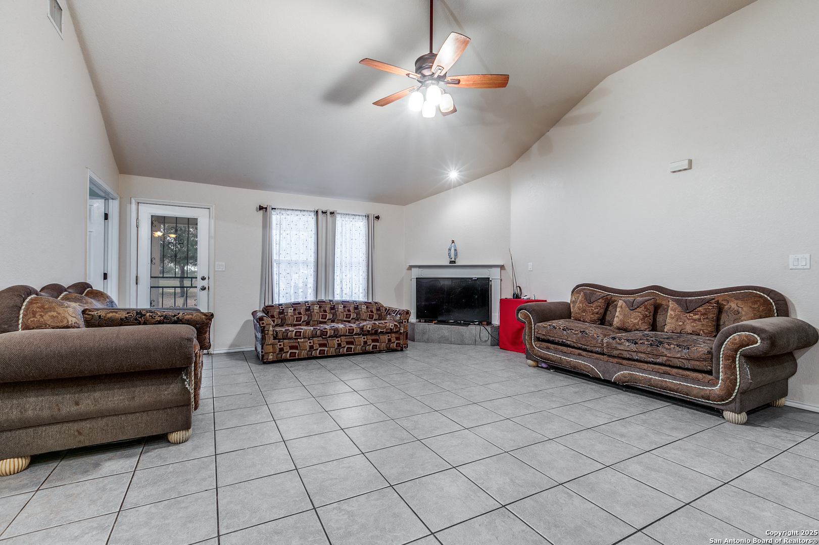 745 Cimarron Square Poteet, TX 78065 - Photo 8 of 33 a living room with furniture and a chandelier