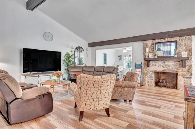 a living room with furniture fireplace and flat screen tv