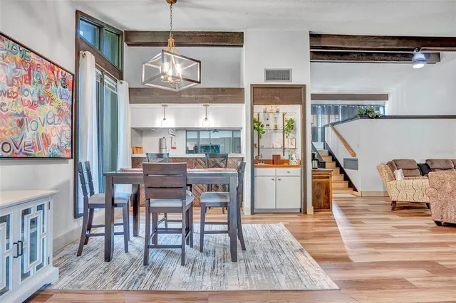 a dining room with furniture entryway and wooden floor
