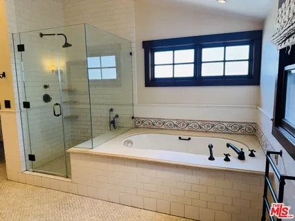 a bathroom with a bathtub and a shower