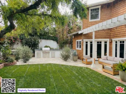 a view of a house with backyard sitting area and garden