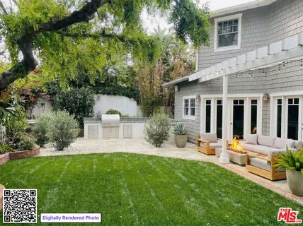 a view of a house with backyard sitting area and garden