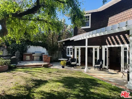 a view of a house with swimming pool and sitting area