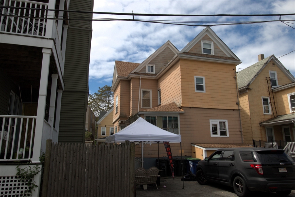 7 Stickney Avenue Somerville, MA 02145 - Photo 2 of 16 a front view of a house with a yard and garage