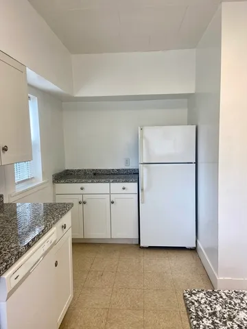a kitchen with granite countertop cabinets and appliances