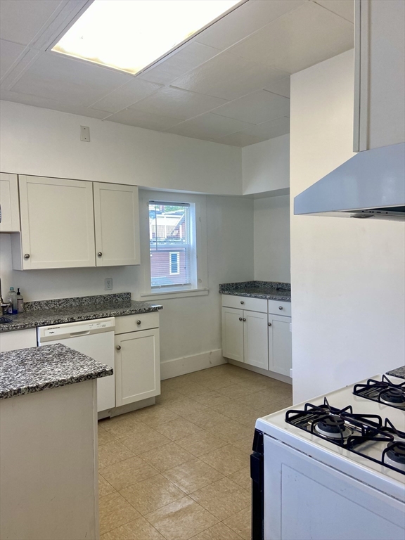 7 Stickney Avenue Somerville, MA 02145 - Photo 4 of 16 a kitchen with granite countertop a sink and a stove