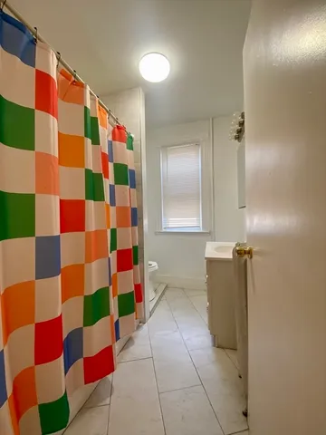 a view of bathroom with mirror and shower