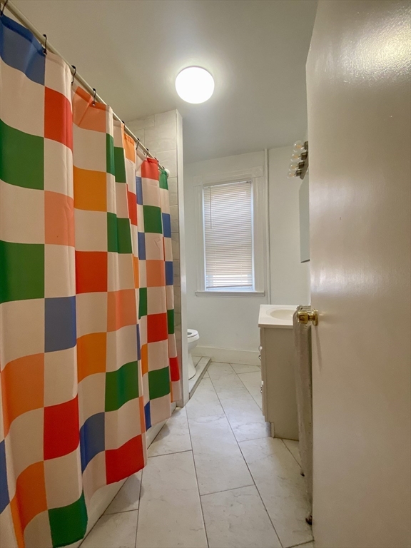 7 Stickney Avenue Somerville, MA 02145 - Photo 6 of 16 a view of bathroom with mirror and shower