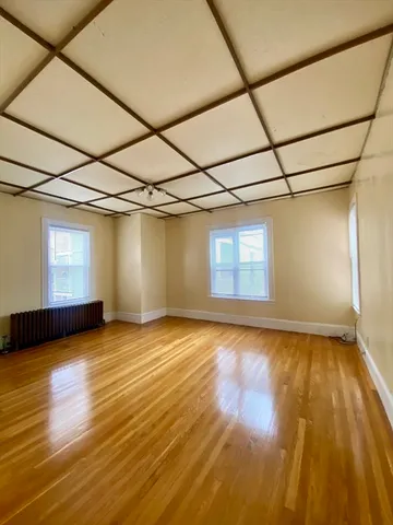 a view of a room with wooden floor and brick walls