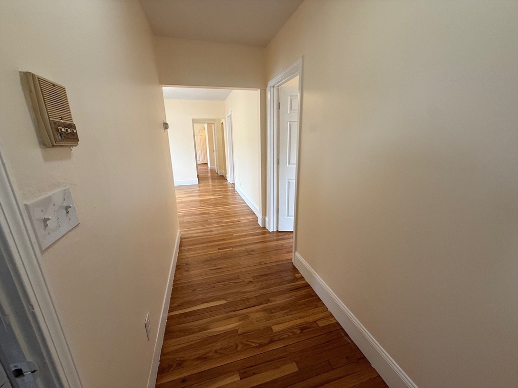 11 Dalrymple Street, Unit 3 Boston, MA 02130 - Photo 2 of 13 a view of a hallway with wooden floor