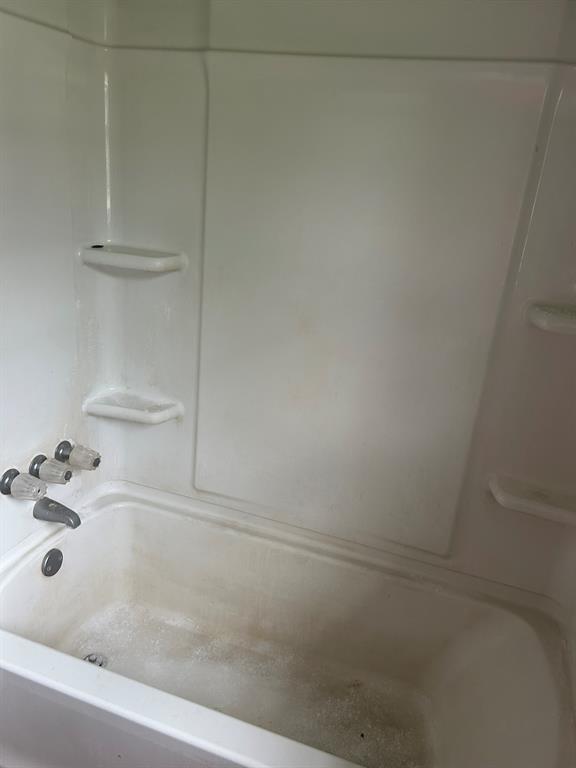 6 Pershing Drive Denison, TX 75020 - Photo 11 of 13 a bathroom with a bathtub