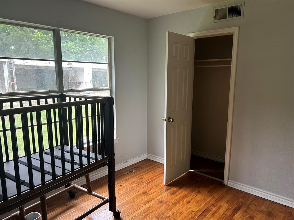 6 Pershing Drive Denison, TX 75020 - Photo 13 of 13 an empty room with wooden floor and windows
