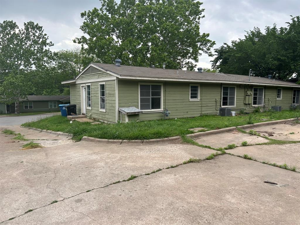 6 Pershing Drive Denison, TX 75020 - Photo 2 of 13 a front view of a house with garden