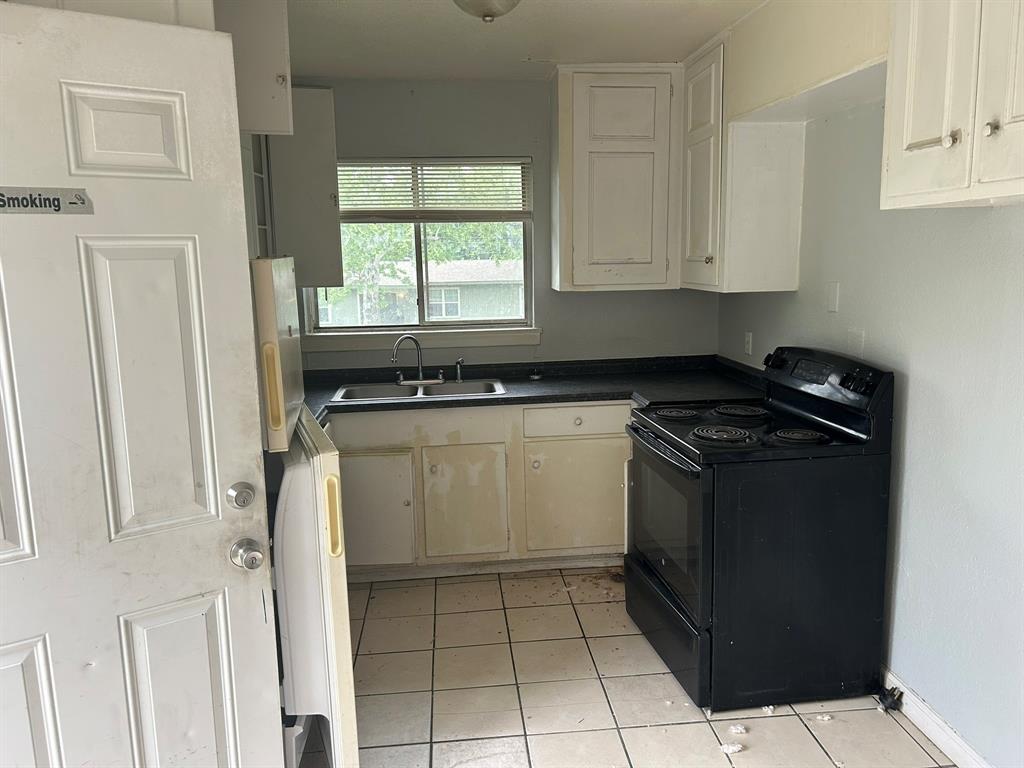 6 Pershing Drive Denison, TX 75020 - Photo 7 of 13 a view of a kitchen with white cabinets