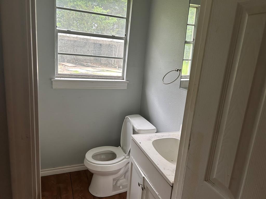 6 Pershing Drive Denison, TX 75020 - Photo 10 of 13 a white toilet sitting next to a window