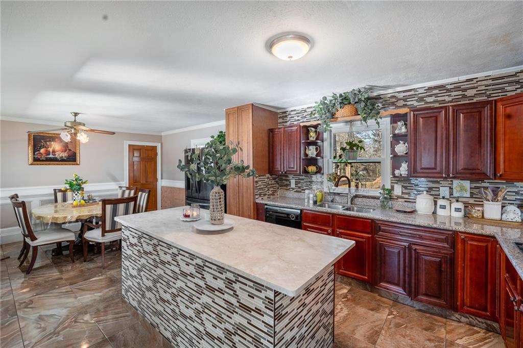 4983 Arcado Road Southwest Lilburn, GA 30047 - Photo 11 of 33 a kitchen with a sink and cabinets
