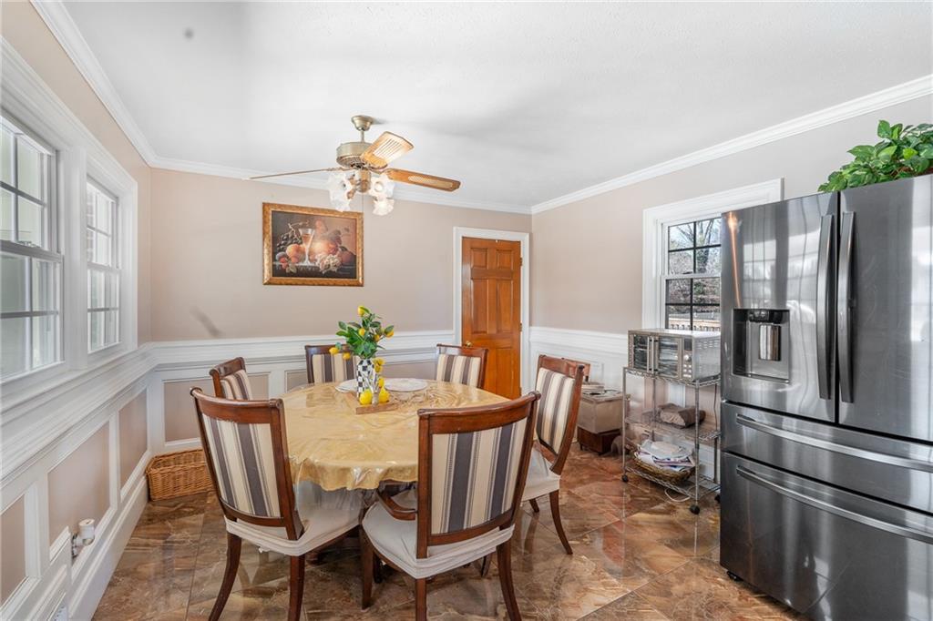 4983 Arcado Road Southwest Lilburn, GA 30047 - Photo 14 of 33 a view of a dining room with furniture window and wooden floor
