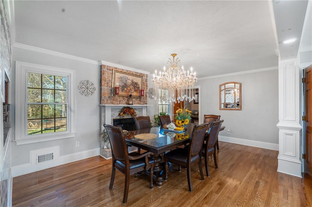 4983 Arcado Road Southwest Lilburn, GA 30047 - Photo 17 of 33 a view of a dining room with furniture a chandelier and wooden floor