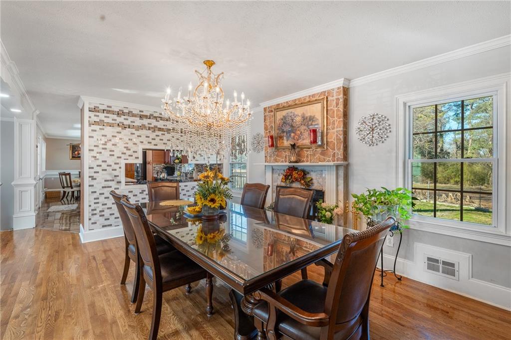 4983 Arcado Road Southwest Lilburn, GA 30047 - Photo 18 of 33 a view of a dining room with furniture window and wooden floor