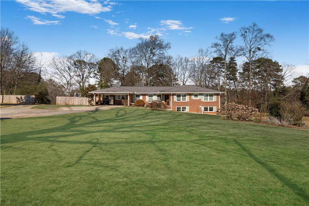 4983 Arcado Road Southwest Lilburn, GA 30047 - Photo 2 of 33 a view of a house with a big yard