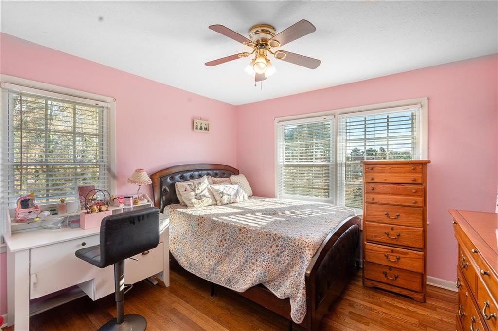 4983 Arcado Road Southwest Lilburn, GA 30047 - Photo 21 of 33 a bedroom with a bed and a chandelier