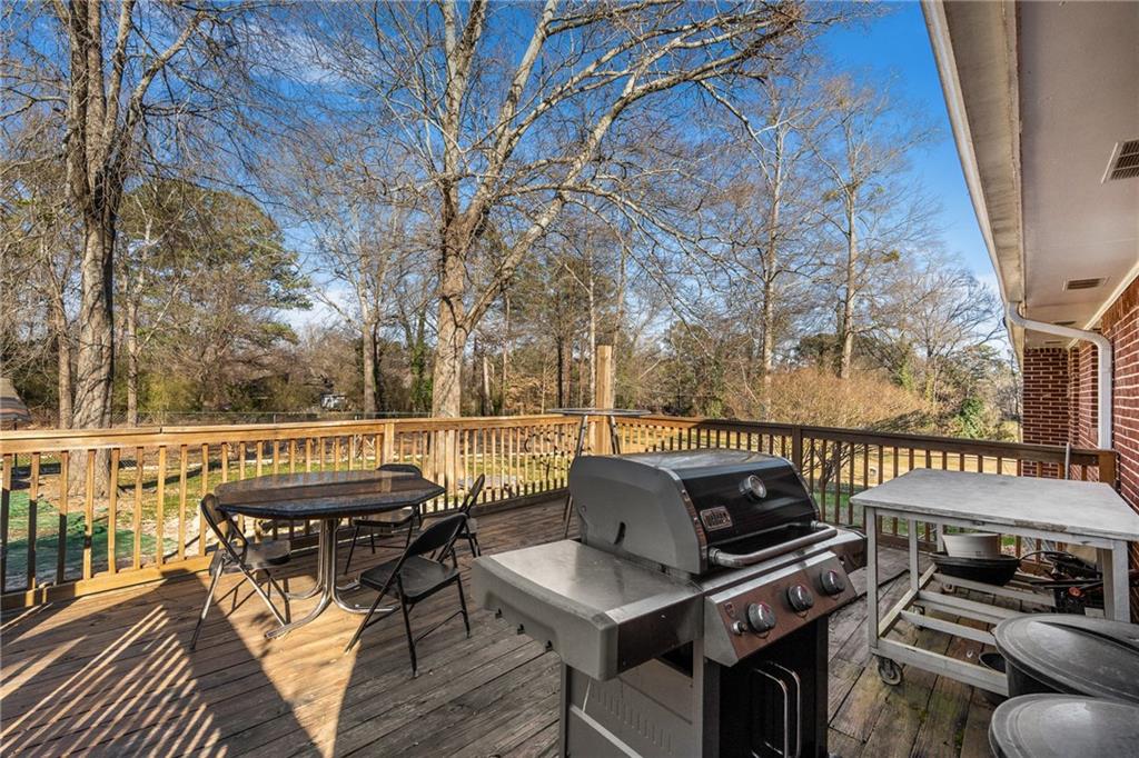 4983 Arcado Road Southwest Lilburn, GA 30047 - Photo 25 of 33 a roof deck with couches and wooden floor
