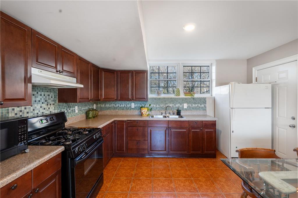 4983 Arcado Road Southwest Lilburn, GA 30047 - Photo 30 of 33 a kitchen with stainless steel appliances granite countertop a stove a sink dishwasher and a refrigerator