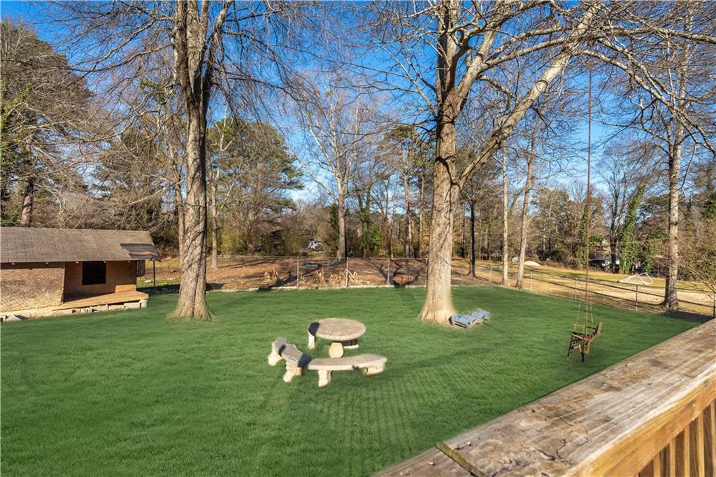 4983 Arcado Road Southwest Lilburn, GA 30047 - Photo 3 of 33 a backyard of a house with lots of green space