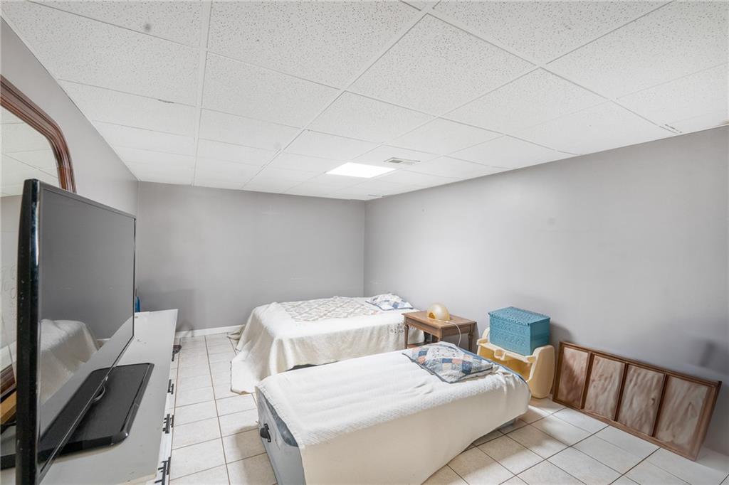 4983 Arcado Road Southwest Lilburn, GA 30047 - Photo 31 of 33 a bathroom with a sink mirror and toilet