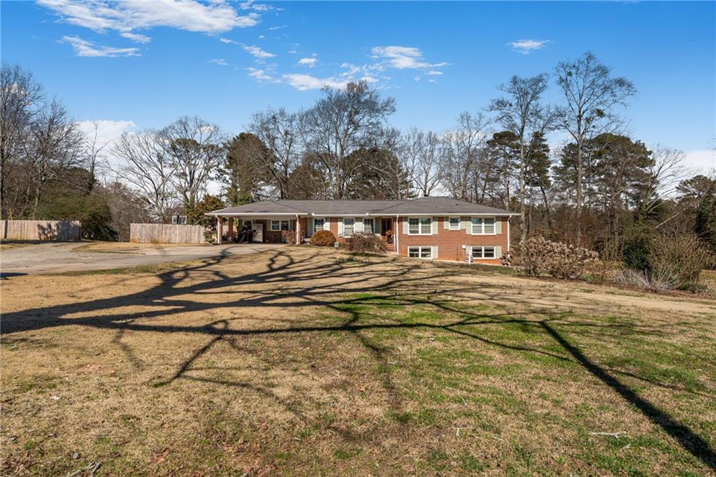 4983 Arcado Road Southwest Lilburn, GA 30047 - Photo 10 of 33 a view of a house with a big yard