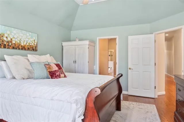 a bedroom with a bed and a painting on the wall