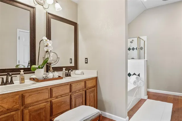 a bathroom with a double vanity sink mirror and toilet