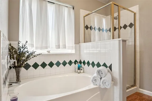 a bathroom with a bathtub and shower