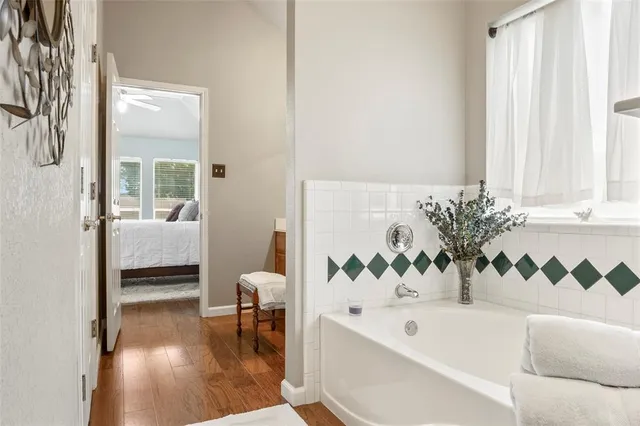a bath room with a bathtub and a window