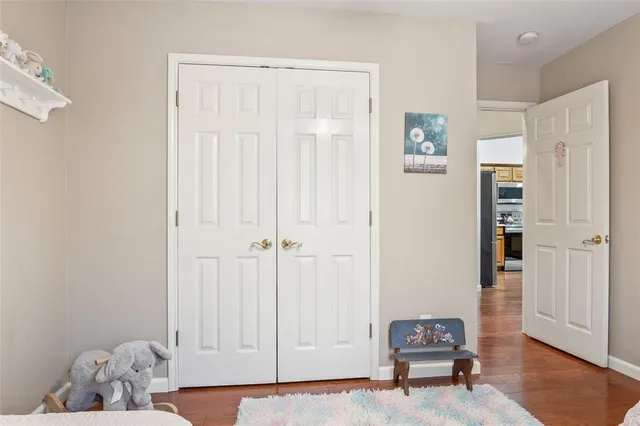 a view of a livingroom with wooden floor and cabinet