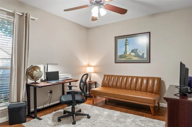 a view of a workspace with furniture and a window