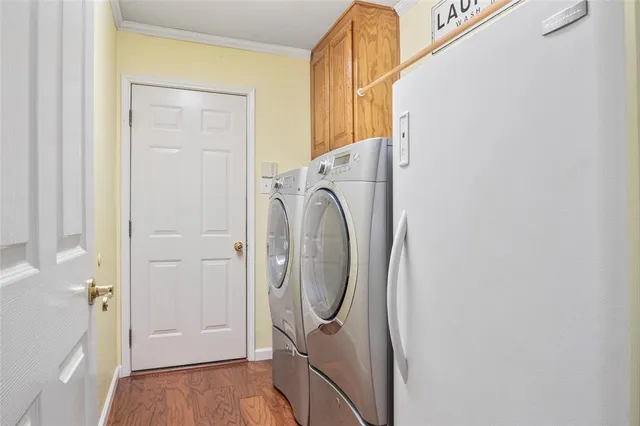a view of a storage and utility room with washer and dryer