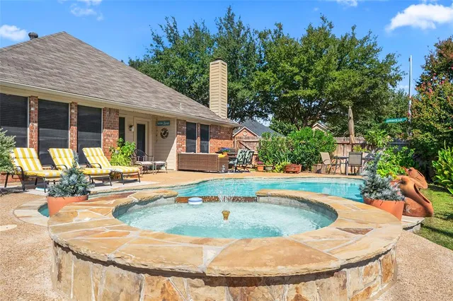 a view of a house with swimming pool and sitting area
