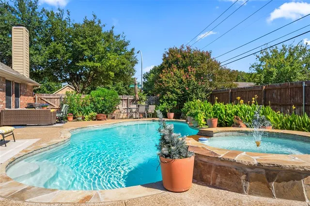 a view of a backyard with plants and patio