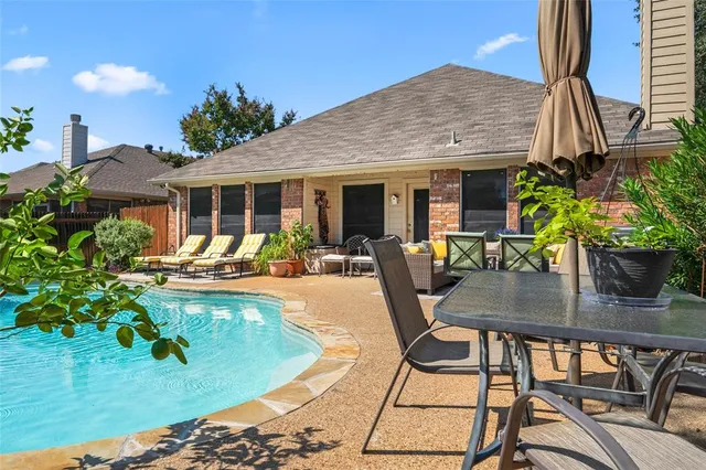 a view of a swimming pool with chairs
