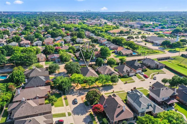 an aerial view of residential houses with outdoor space